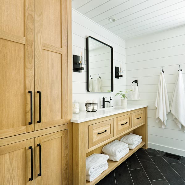bathroom with natural wood cabinetry
